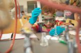 Student working in a lab wearing goggles